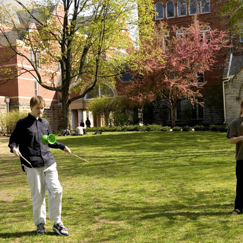 Two students playing diabolo on the Great Lawn